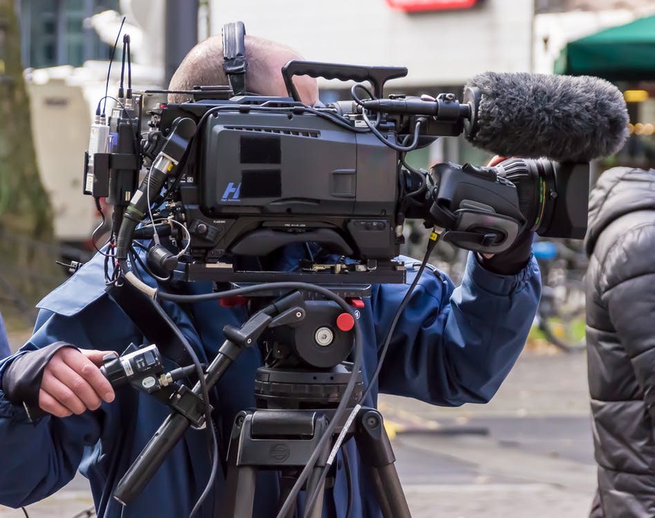 Broadcast camera operator filming an interview in Orlando