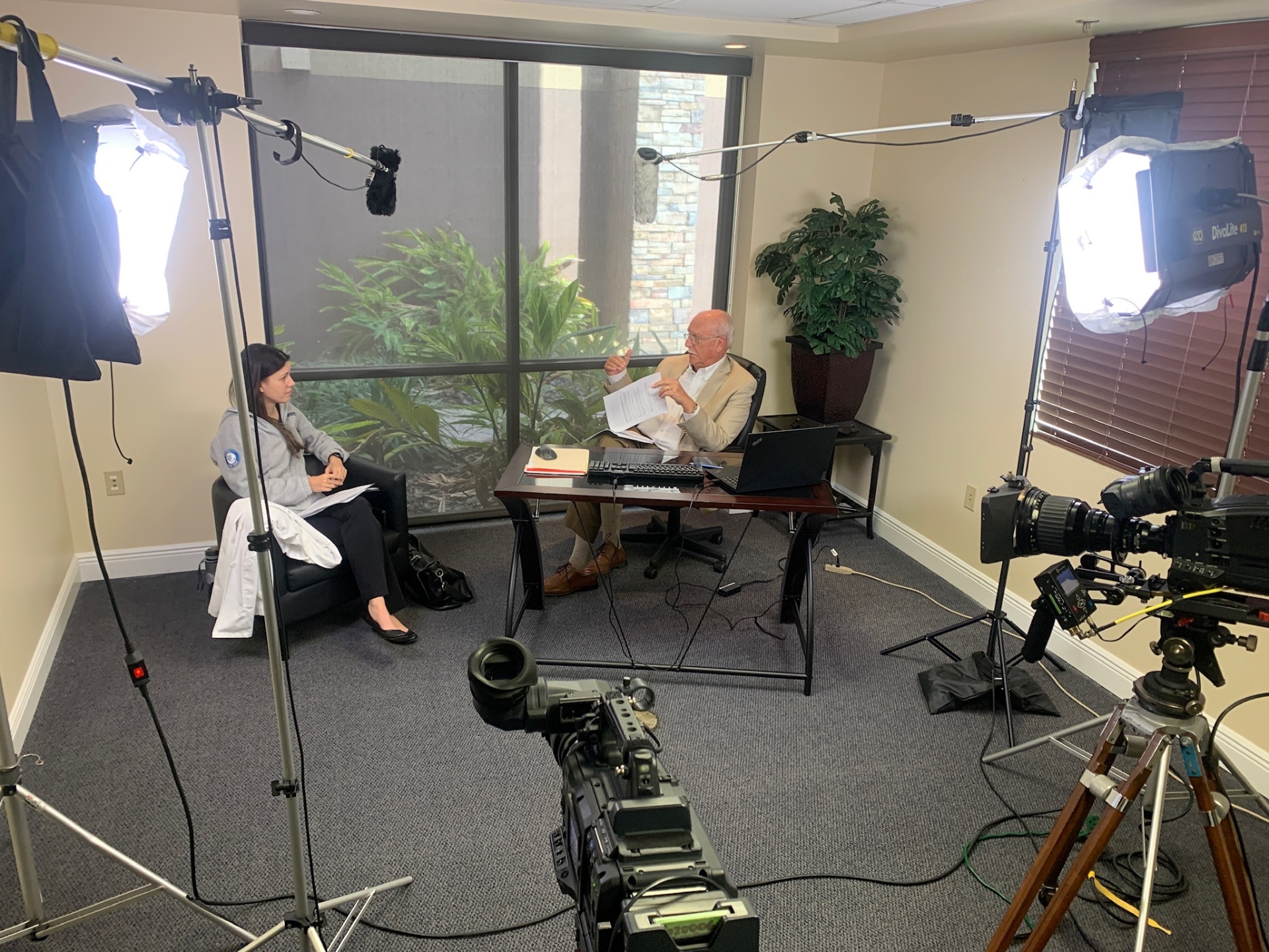 Three-camera interview setup with lighting and boom mics on location in Central Florida